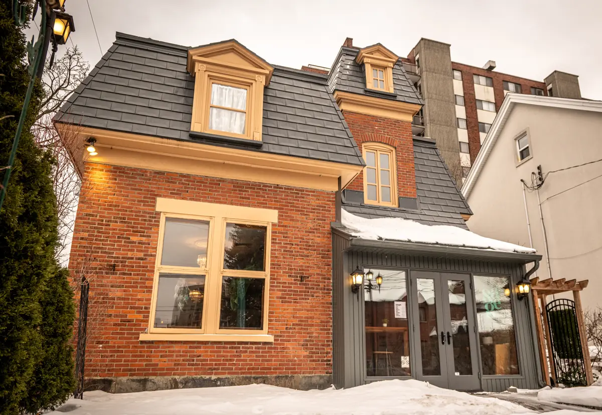 La Maison hOMe — the brick house in Saint-Lambert that holds the café, the studio and the gatherings.